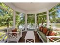 Comfortable screened porch featuring wicker furniture and scenic lake views at 81002 Alexander, Chapel Hill, NC 27517