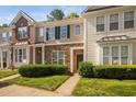 Charming townhome with stone accents, a well-manicured lawn, and a welcoming front entryway at 8422 Central Dr, Raleigh, NC 27613