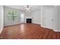 Bright living room with hardwood floors, fireplace, and large windows providing natural light at 8422 Central Dr, Raleigh, NC 27613