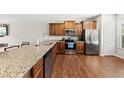 Spacious kitchen features stainless steel appliances, island and hardwood floors at 8885 Commons Townes Dr, Raleigh, NC 27616