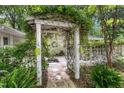 Vine-covered pergola at entrance with hanging planters and stone pathway at 914 Cindy St, Cary, NC 27511