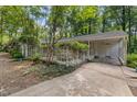 Side exterior of home with lush greenery and shaded carport at 914 Cindy St, Cary, NC 27511
