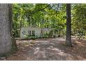 Quaint front exterior with mature trees, gravel drive and decorative accents at 914 Cindy St, Cary, NC 27511