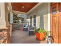 Cozy covered front porch with comfortable seating and elegant decorative accents at 997 Windy Rd, Apex, NC 27502