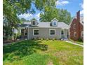 Charming grey home featuring a well-manicured lawn and dormer windows at 1022 Carolina Ave, Durham, NC 27705