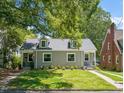 Charming grey home featuring a well-manicured lawn and dormer windows at 1022 Carolina Ave, Durham, NC 27705