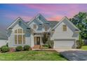 Charming two-story traditional home featuring a manicured lawn, attached garage, and welcoming entrance with brick steps at 103 Equestrian Ct, Cary, NC 27513