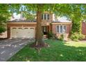 Brick and stone home with a manicured lawn, attached garage, and mature shade trees in the front yard at 107 Sonoma Valley Dr, Cary, NC 27518