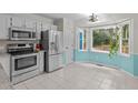 Well-lit kitchen features stainless steel appliances and a large window overlooking the backyard at 112 Barcelona Ct, Cary, NC 27513