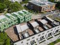 Aerial view of modern townhomes with rooftop patios and green construction next door at 1311 Chamblee Hill Ct, Raleigh, NC 27608