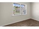 Bright bedroom with hardwood floors, a window with a view of the outdoors, and neutral walls at 137 Pisgah St, Sanford, NC 27330