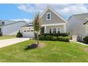Lovely home showcasing green lawn, trimmed shrubs, and a cozy covered porch at 149 Ivory Ln, Raleigh, NC 27610