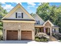 Beautiful home featuring a large two-car garage, stone accents, and well-maintained landscaping at 150 Luxorwind Dr, Garner, NC 27529