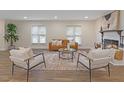 Bright living room with a cozy fireplace, neutral furniture, and a large area rug at 1709 Hawthorne Lane Ln, Burlington, NC 27215
