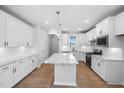 Bright kitchen featuring white cabinets, granite countertops, and stainless steel appliances at 173 Churchill Way, Clayton, NC 27520
