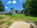 Expansive backyard with a concrete patio, perfect for outdoor entertaining, awaiting landscaping and personalization at 1804 Falls Landing Dr, Raleigh, NC 27614