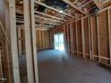 Unfinished room exhibiting exposed beams and a sliding glass door at 1808 Falls Landing Dr, Raleigh, NC 27614