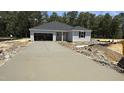 New home construction featuring a long, newly poured driveway and two car garage at 189 Gobbler Dr, Smithfield, NC 27577