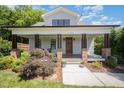 Inviting covered porch with stylish columns and landscaping enhances the facade at 200 W Corbin St, Hillsborough, NC 27278