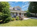 Attractive home showcasing a well-kept lawn and mature trees surrounding the property at 200 W Corbin St, Hillsborough, NC 27278
