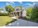 Beautiful property with a well-maintained lawn, covered front porch, and private driveway at 200 W Corbin St, Hillsborough, NC 27278