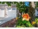 Landscaped flowerbed near a brick home with a two-car garage enhances curb appeal at 2007 October Dr, Durham, NC 27703