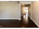 Elegant living room with dark hardwood flooring, neutral paint, and an open floor plan at 2008 Campana Dr, Raleigh, NC 27603