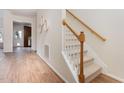 Inviting foyer boasts wood floors, a carpeted staircase, and an entryway into the kitchen at 202 Chapel Valley Ln, Apex, NC 27502