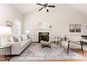 Bright living room with a fireplace, high ceiling, ceiling fan, and lots of natural light at 202 Chapel Valley Ln, Apex, NC 27502
