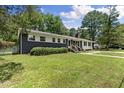 A beautifully renovated home with a combination of dark painted brick and white siding at 202 Purvis St, Garner, NC 27529