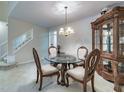Formal dining area featuring a glass-top table, ornate chairs, and a display cabinet at 2109 Star Sapphire Dr, Raleigh, NC 27610