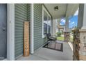 Cozy front porch with a chair and decor, perfect for relaxing and enjoying the neighborhood views at 2123 Scarlet Sage Dr, Durham, NC 27704