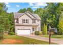 Charming two-story home featuring a well-maintained lawn and an attached two-car garage at 2555 Winding Creek Ln, Franklinton, NC 27525