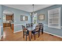 Cozy dining room with blue walls, wood floors, and a window for natural light at 2605 Bloomsberry Ridge Dr, Fuquay Varina, NC 27526