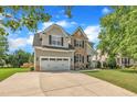 Beautiful two-story home with a well-maintained lawn and a spacious driveway leading to a two-car garage at 2605 Bloomsberry Ridge Dr, Fuquay Varina, NC 27526