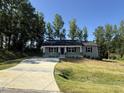 Well-maintained single-story home with stone accents and a lush green lawn at 299 Starry Sky Dr, Benson, NC 27504