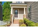 Inviting front entrance featuring a decorative glass door, brick steps, and tasteful landscaping for a warm welcome at 304 Garden Walk Dr, Durham, NC 27703