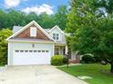 Craftsman-style home with lush landscaping and a two-car garage, blending charm and convenience at 322 Bellemont Rd, Pittsboro, NC 27312