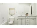 Bright bathroom featuring double sinks, a vanity, a large mirror, and a shower-tub combination at 42 Playtime Cir, Princeton, NC 27569