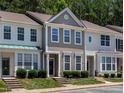 Charming townhome featuring two-story design, neat landscaping, and neutral exterior at 4536 Sugarbend Way, Raleigh, NC 27606