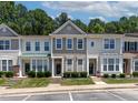 Charming townhome featuring two-story design, neat landscaping, and neutral exterior at 4536 Sugarbend Way, Raleigh, NC 27606