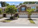 Charming townhome featuring a two-car garage, and beautifully maintained landscaping at 469 Methven Grove Dr, Cary, NC 27519