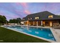 Backyard view with a sparkling pool, manicured lawn, outdoor seating, and a pergola at 4725 Saratoga Falls Ln, Raleigh, NC 27614