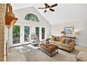 Sunlit living room with french doors, cozy seating, and neutral decor at 4816 Marlborough Way, Durham, NC 27713