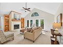 Bright living room with vaulted ceilings, fireplace, and access to the deck at 4816 Marlborough Way, Durham, NC 27713