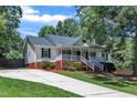 Attractive home with a covered porch, set on a well-maintained lot with a paved driveway at 52 Malcolm Dr, Clayton, NC 27520