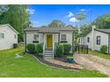 Charming cottage with yellow door, nice landscaping and a Wendell water tower at 527 N Cypress St, Wendell, NC 27591