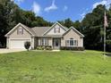 Well-maintained home with an attached garage and lush lawn, complemented by a flagpole at 55 Ridge Haven Dr, Louisburg, NC 27549