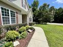 Landscaped pathway leading to a charming home, accentuated with a flagpole at 55 Ridge Haven Dr, Louisburg, NC 27549