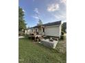 Wide backyard view featuring deck, patio, wood benches, and room for outdoor living at 5809 Iris Lake Ct, Raleigh, NC 27604